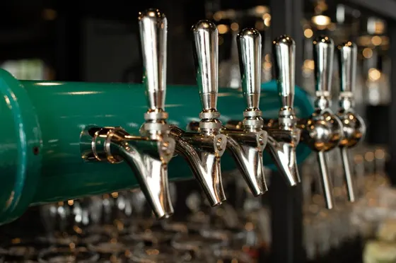 Row of wine glasses lined up on a machine