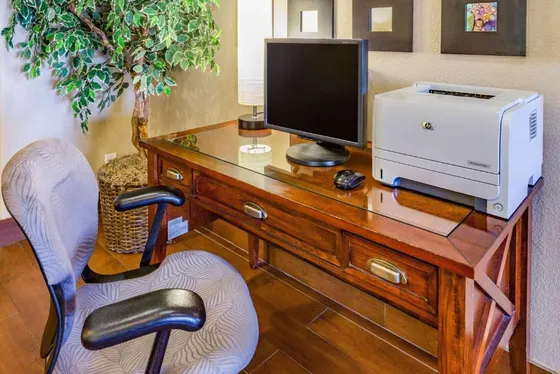 Desk with a computer and a printer on it