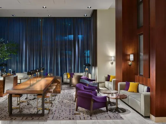 Hotel lobby with purple chairs and a table