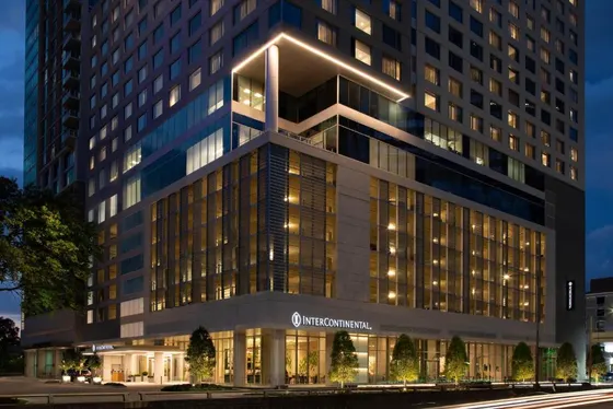 High-rise at dusk with a glowing InterContinental sign