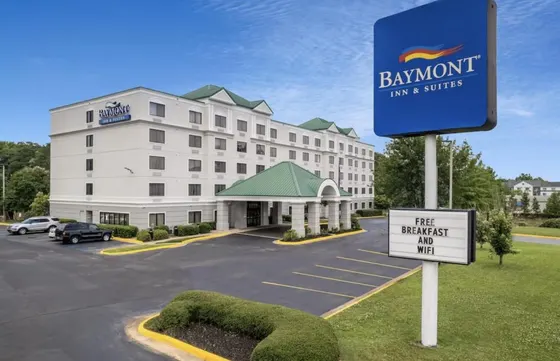 Hotel with a sign in front of a parking lot
