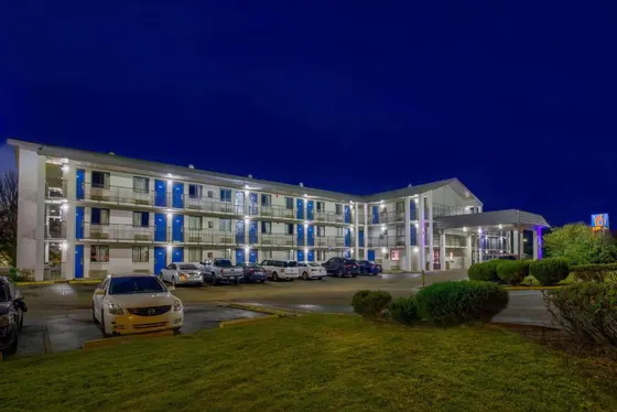 Large building with cars parked in a parking lot