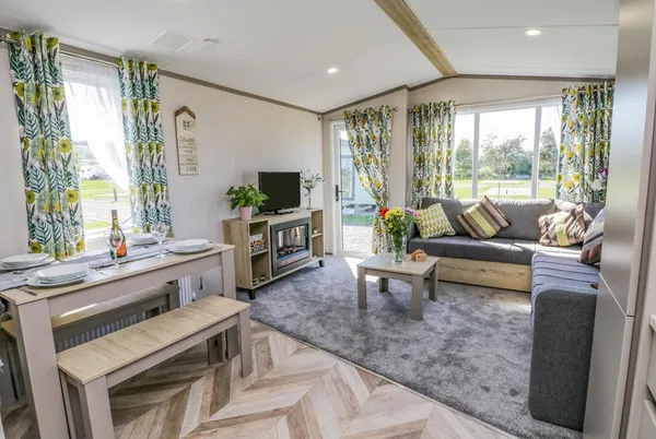 Jean's Place open-plan living with herringbone floor and fireplace