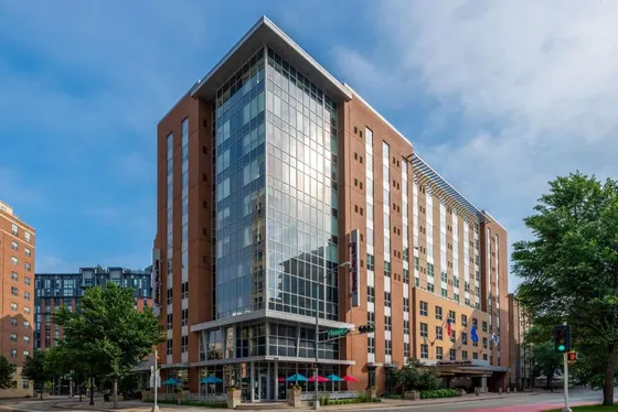 Tall glass building on a city street