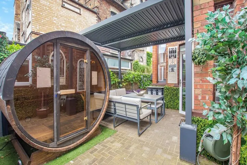 Jorvik Villas private courtyard with barrel sauna and seating area