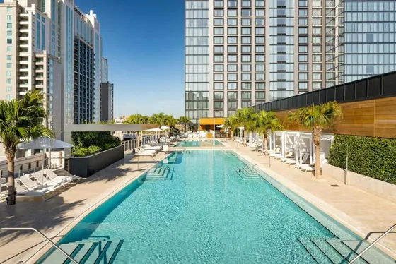 Overhead view of a swimming pool with chairs and buildings