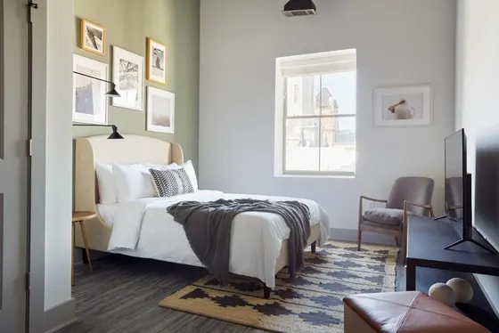 Bedroom with a white bed and a window