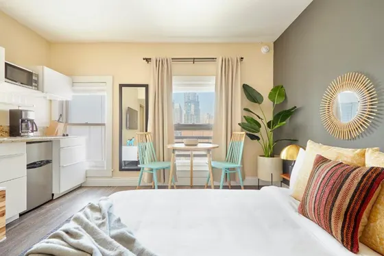 Bedroom with a bed and a table with chairs