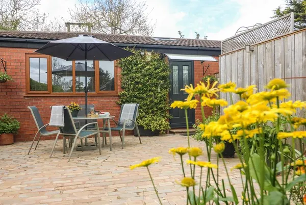 Kilmory Lodge stone courtyard patio with outdoor dining set