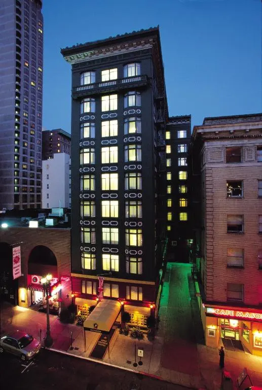 Tall building with lit windows in a city at night