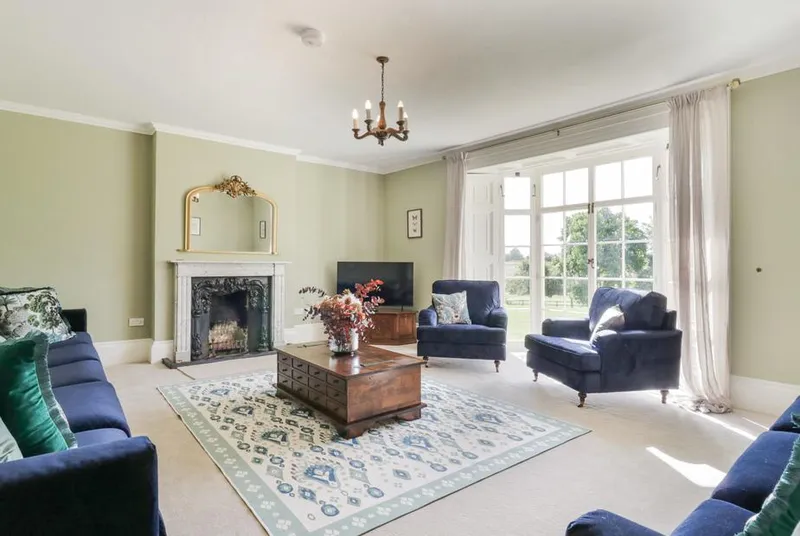 Knights Farm living room with beams, wood panelling and sash windows