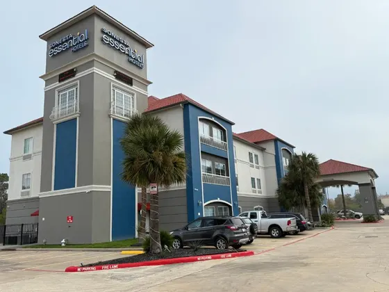 Gray hotel with blue panels and a Sonesta Essential sign