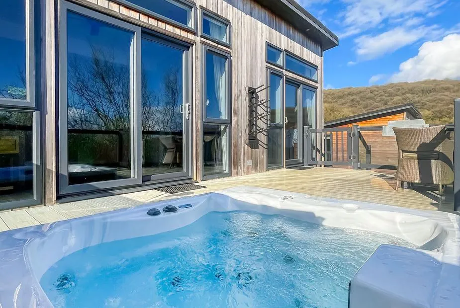 Langford Premier hot tub filled with blue water on private deck with Mendip hills behind