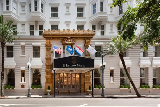 Black awning with Le Pavillon Hotel lettering over gold doors