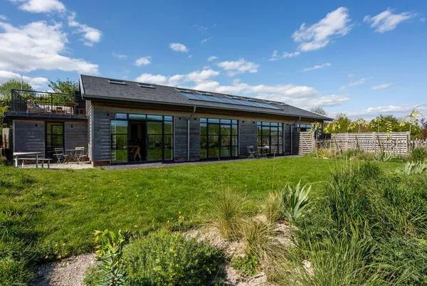 Oakwood Barn front glass facade with landscaped garden