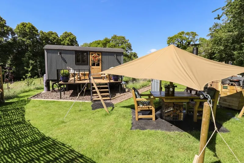 Limetree Luxury Glamping Southdown canopy dining area and hut in enclosed garden