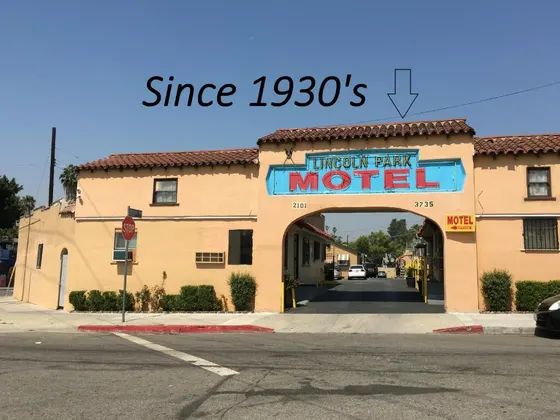 Building with a sign that reads entrance to a motel