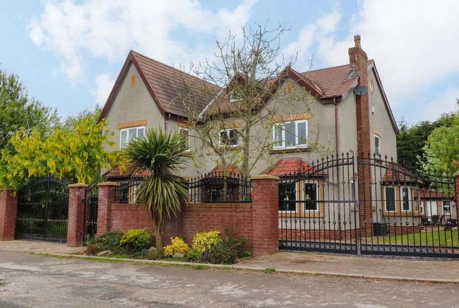 Linwood front elevation of the house with a lawn