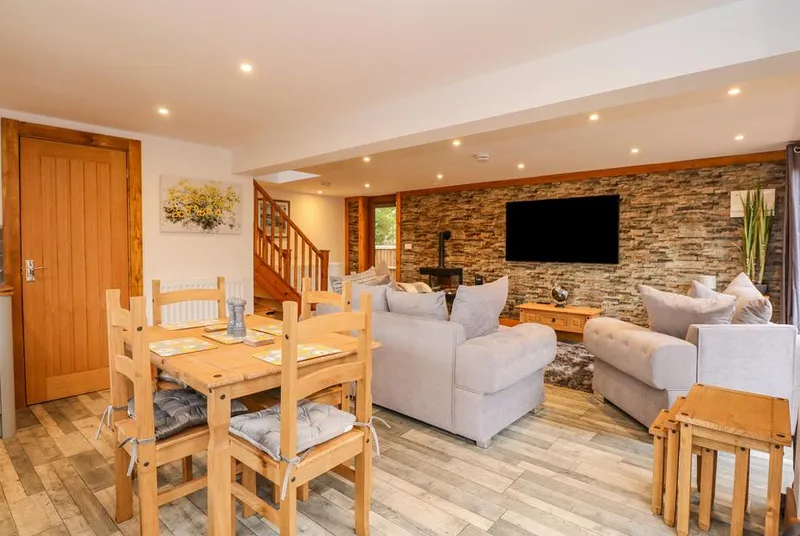 Little Lodge living area with stone feature wall and wood burner