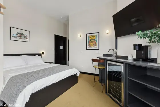 Hotel room with a bed and a kitchen