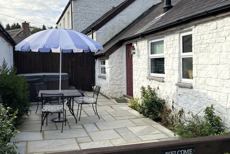 The Barn at Waunlippa courtyard terrace beside the tucked-away hot tub
