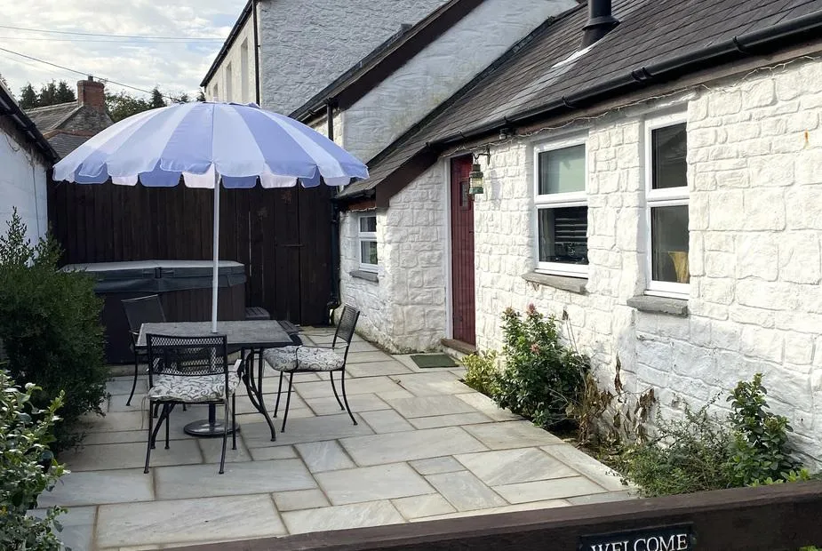 The Barn at Waunlippa courtyard terrace beside the tucked-away hot tub