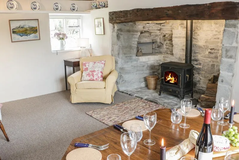 Lower Hodre inglenook dining area with wood burner