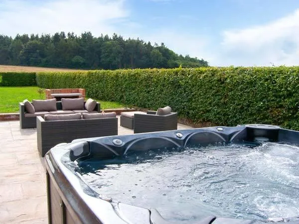 Lower Lodge hot tub beside the patio and fields