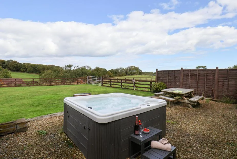 Hayloft hot tub with countryside views and picnic table