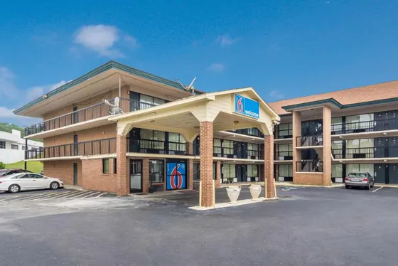 Hotel with a parking lot in front of it