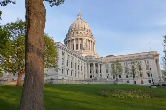 Wisconsin State Capitol beyond a tree-lined lawn