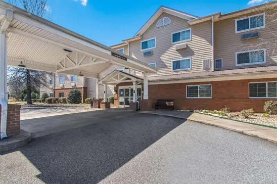 Building with a covered driveway in front of it