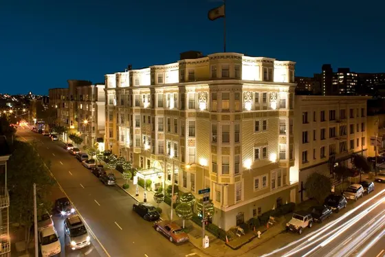 Large white building on a city street at night