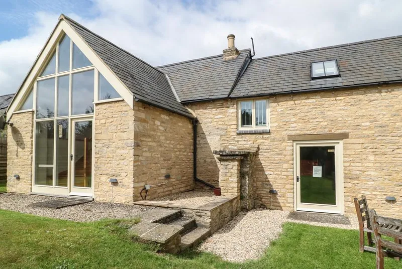 Malt Barn stone barn exterior with full-height glazed gable