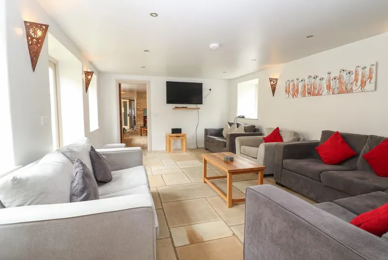 Malt Barn bright lounge with grey sofas and tiled floor