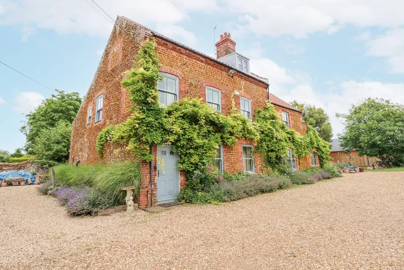 Malthouse Farm ivy-clad red brick farmhouse with gravel drive