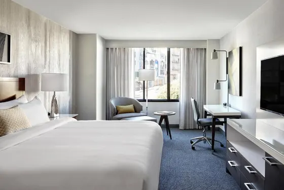 Hotel room with a large bed and a desk
