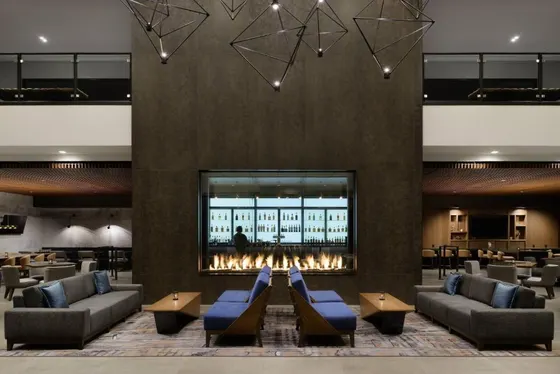 Lobby with couches and a fireplace and a bar