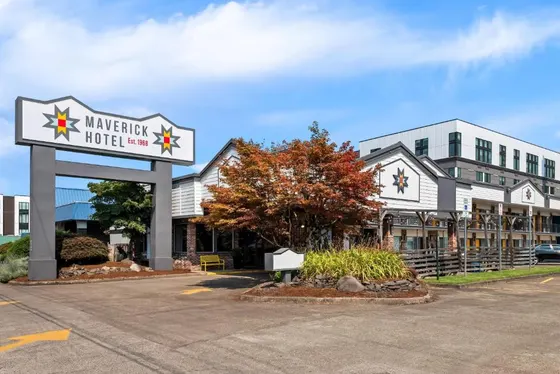 Building with a hotel sign in a parking lot