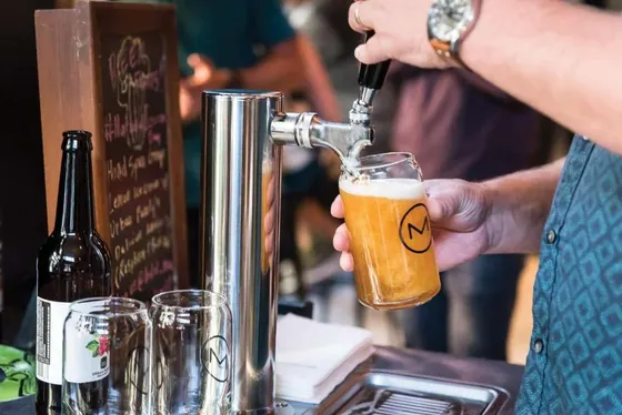 Person is pouring a beer into abeerurrection