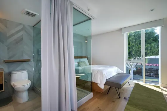 Bedroom with a bed and a toilet and a window