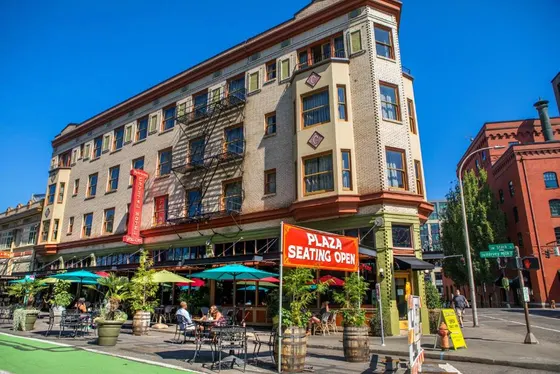 Building with a sign in front of a restaurant