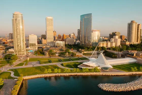 Milwaukee skyline and art museum beside Lake Michigan in golden light