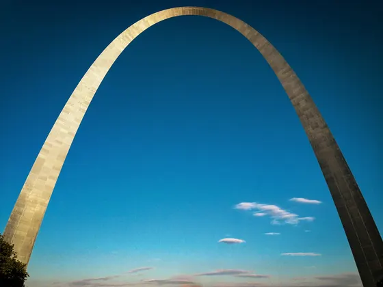 Gateway Arch against a deep blue sky