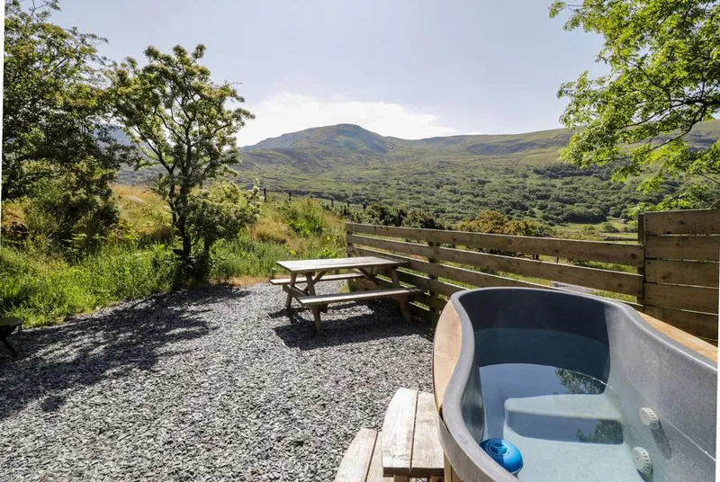 Moelfre Shepherds Hut hot tub with mountain backdrop