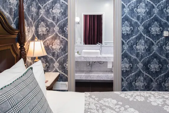 Bedroom with a bed and a bathroom with a sink