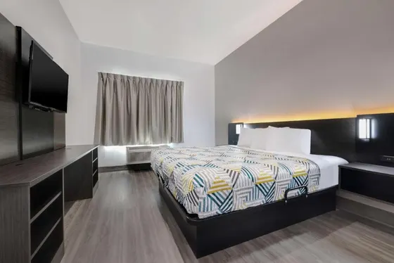 Room with a triangle bedspread and a long desk