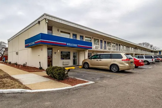 Building with cars parked in a parking lot