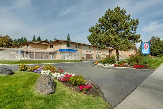 Hotel with flowers in front of a building