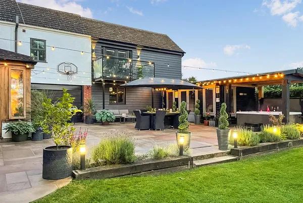 Myrtle Cottage rear property at dusk with festoon lights and garden